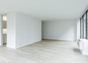 Thumbnail 8 of 8 - A white room with a sliding door and a window.