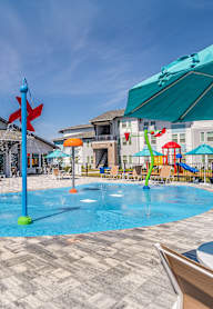 A pool area with a blue umbrella and a red flag.