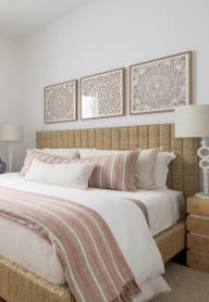a bedroom with a bed and a table with a plant