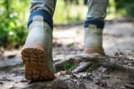 a close up of a person walking on a trail