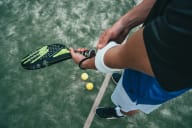 a man holding a tennis racquet on a tennis court