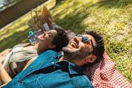 a man and a woman laying down on the grass