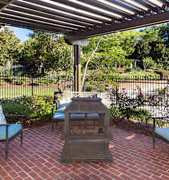 A patio with a fireplace and chairs at Austin Chase Apartments, Macon, GA 31210