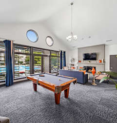 A room with a pool table and a couch.