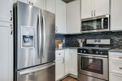 white cabinets and stainless appliances in premium white finish apartment