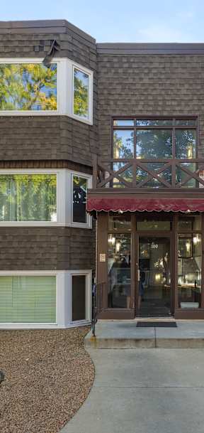 A modern house with a red awning at the entrance.