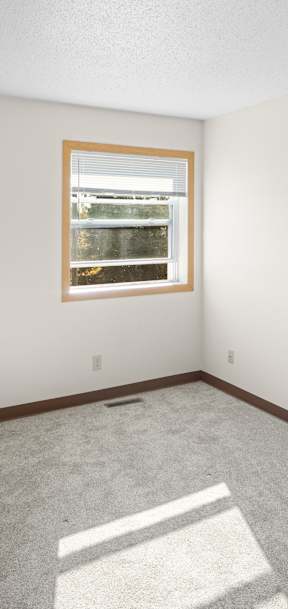A room with a window and carpeted floor.