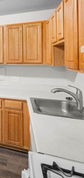 A kitchen with wooden cabinets and a white refrigerator.