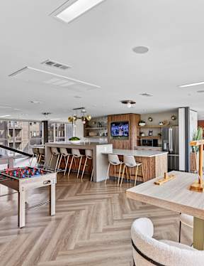A modern dining area with a long table and chairs.
