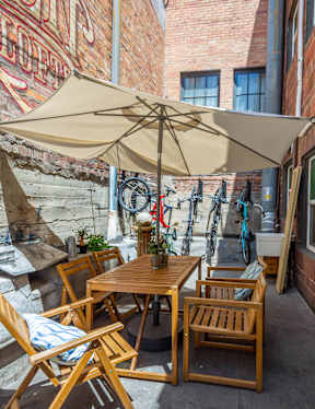 A patio with a table and chairs under an umbrella.