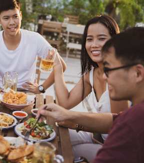 A group of people enjoying a meal together at Victory Northgate Apartments, Washington
