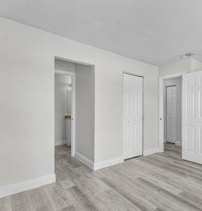 A room with a white door and a white wall.