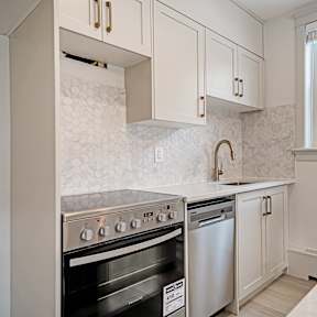 A kitchen with a stove top oven and a dishwasher.