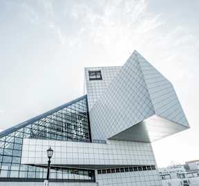 the building is shaped like a triangle and has a glass facade