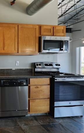 A kitchen with wooden cabinets and stainless steel appliances.