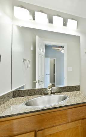 A bathroom with a sink, toilet, and bathtub.