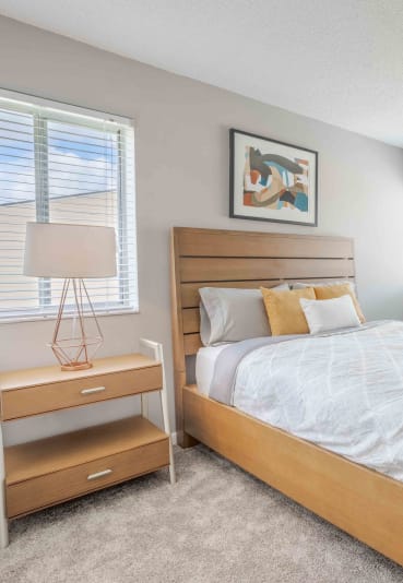 a bedroom with a bed and two windows