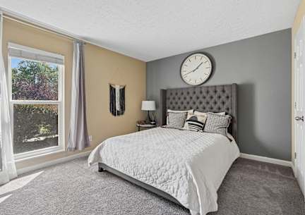 a bedroom with a bed and a clock on the wall