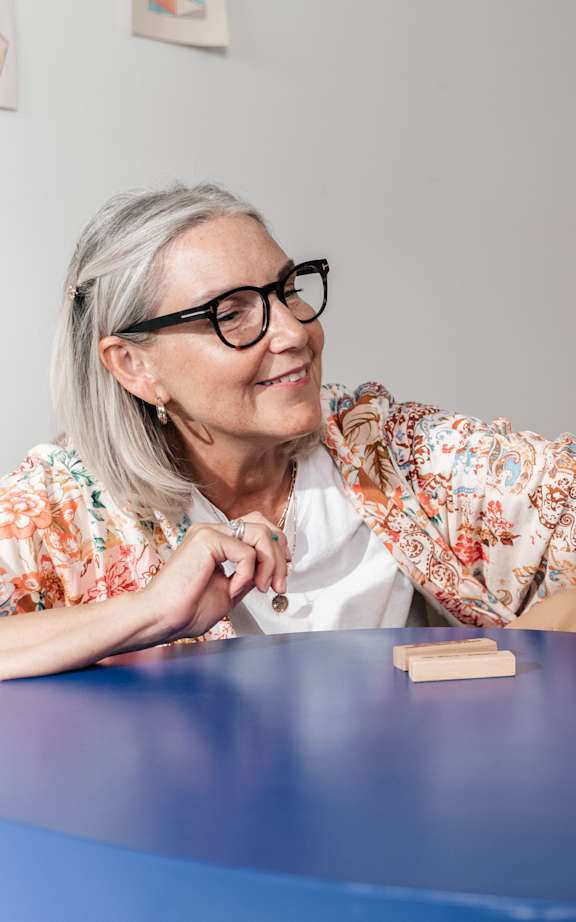 Two elderly people playing a game of Jenga.