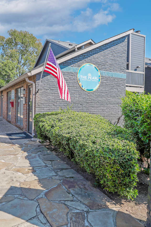 A stone pathway leads to a building with a sign that reads "The Bay.".