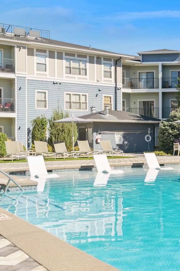 a swimming pool in front of an apartment building