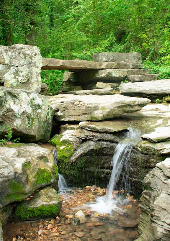 A small waterfall flows over a rocky outcrop.