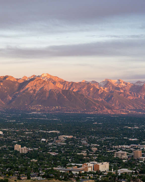 A cityscape with a mountain range in the background.