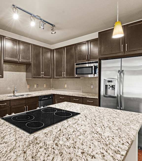 a kitchen with stainless steel appliances and granite counter tops