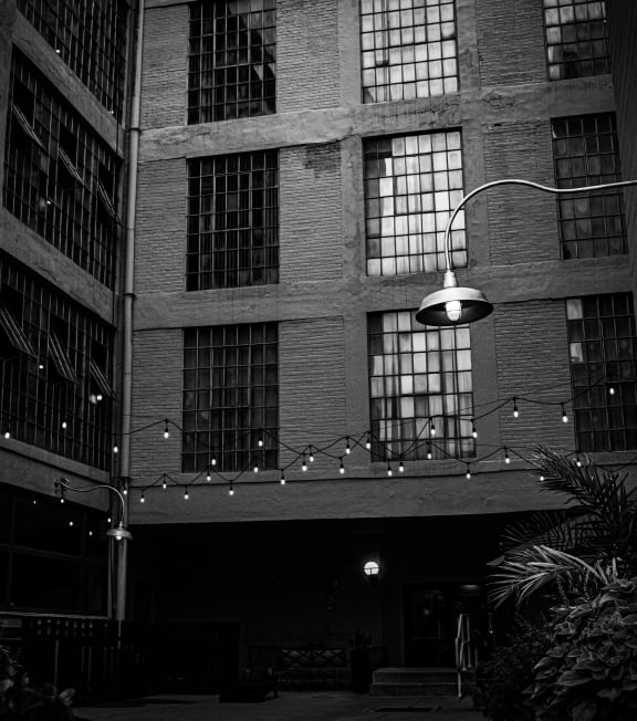 a black and white photo of an old building at night