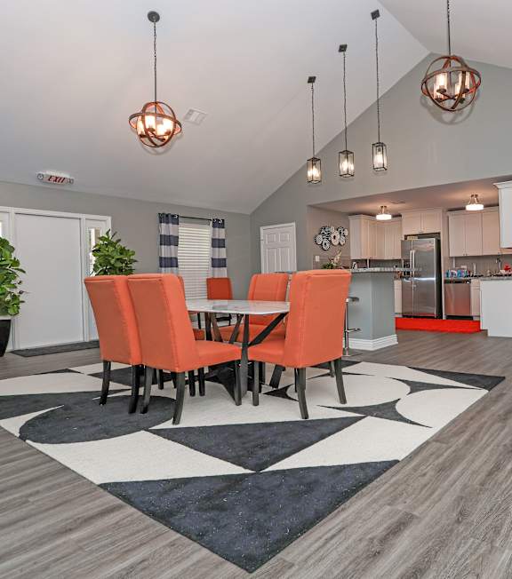 A dining room with a table and chairs.