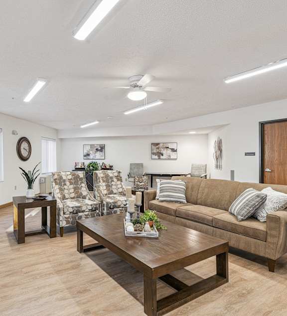 a living room and kitchen with a couch and a table