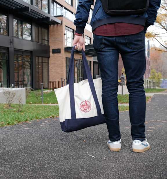 A man holding a canvas tote bag at The Glover House Apartments, Washington, DC