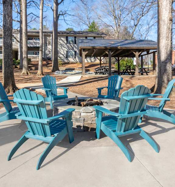 A set of six blue chairs are arranged around a table.