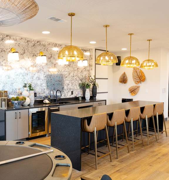 A modern kitchen with a black countertop and white cabinets.