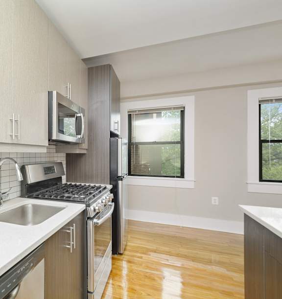 a kitchen with a stove top oven next to a sink