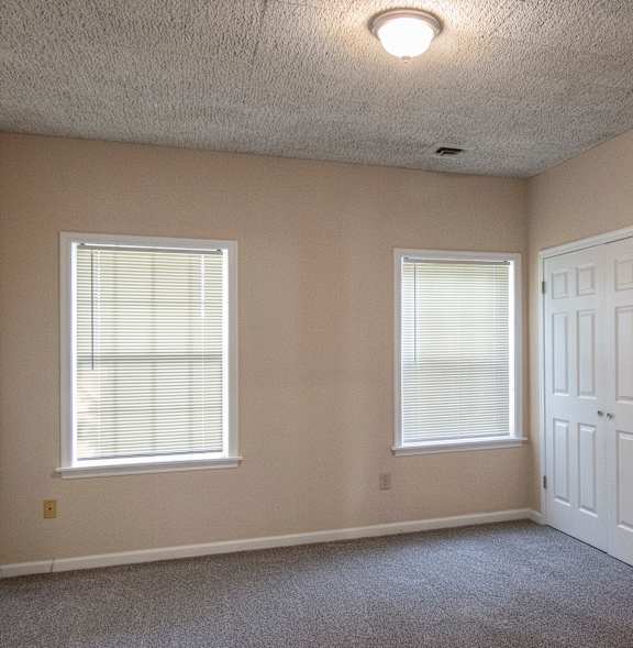 A room with a ceiling fan and a window.
