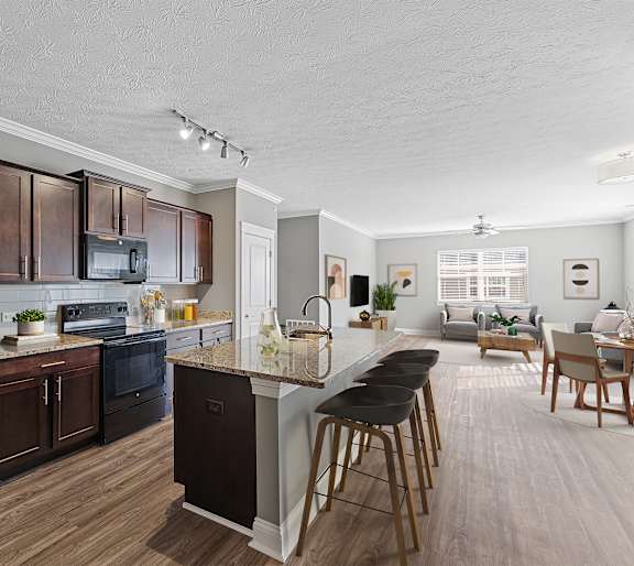 A modern kitchen with dark wood cabinets and a black refrigerator.