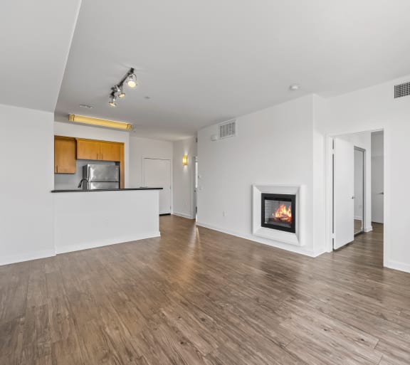 a living room with a fireplace and hardwood floors
