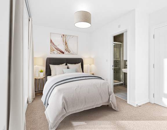 A bedroom with a large bed and a painting on the wall.