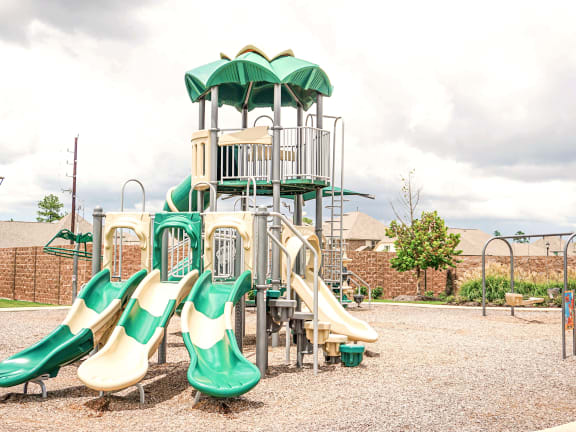 a playground with a climbing structure and slides