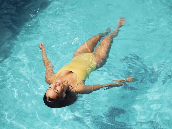 a woman floating in a swimming pool
