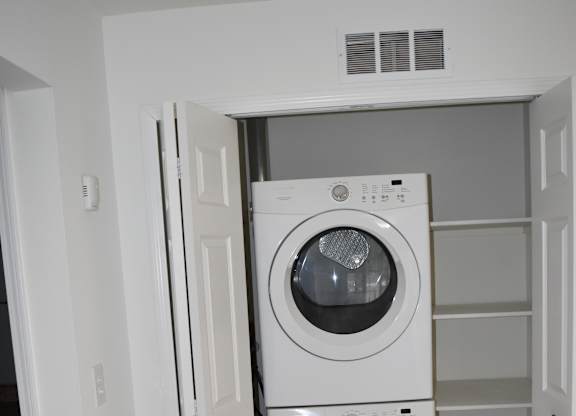 A washing machine and dryer are installed in a wall at Sunnymede Apartments in Troy, MI
