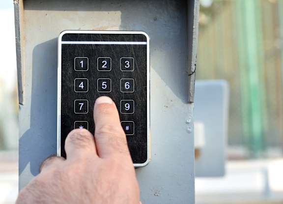 A person is pressing the number 5 on a keypad.
