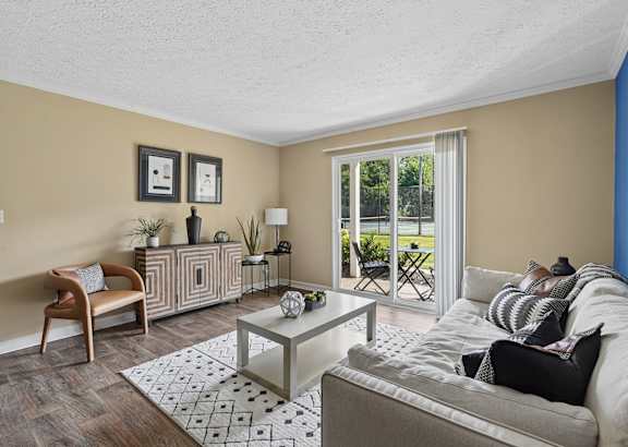 a living room with a couch and a tv and a bed