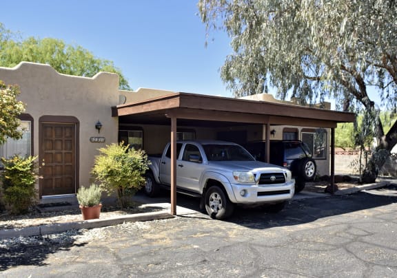A silver truck is parked in front of a house at San Xavier Casitas, Arizona, 85716