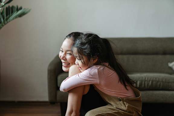Two people hugging each other in a living room.