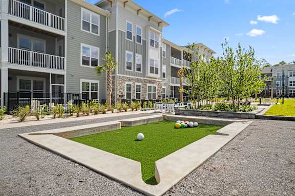 A grassy area in front of apartment buildings.