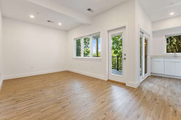 A room with wooden floors and white walls.
