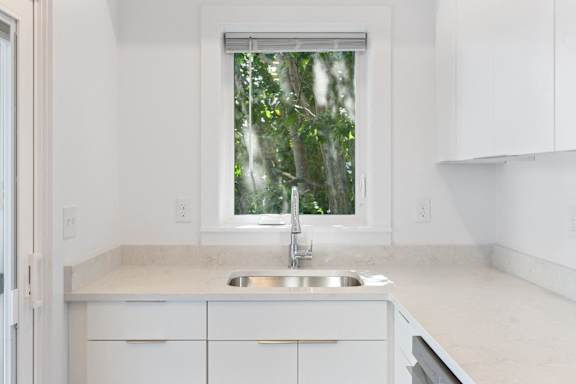 A kitchen with a sink and a window.