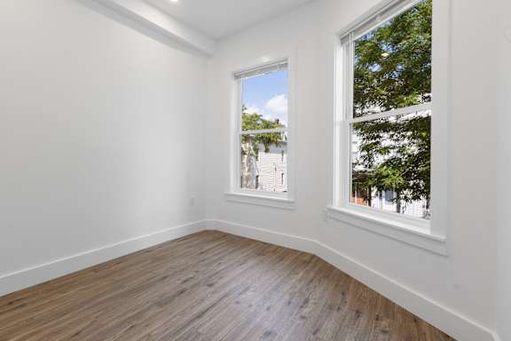 A room with a window overlooking a street.